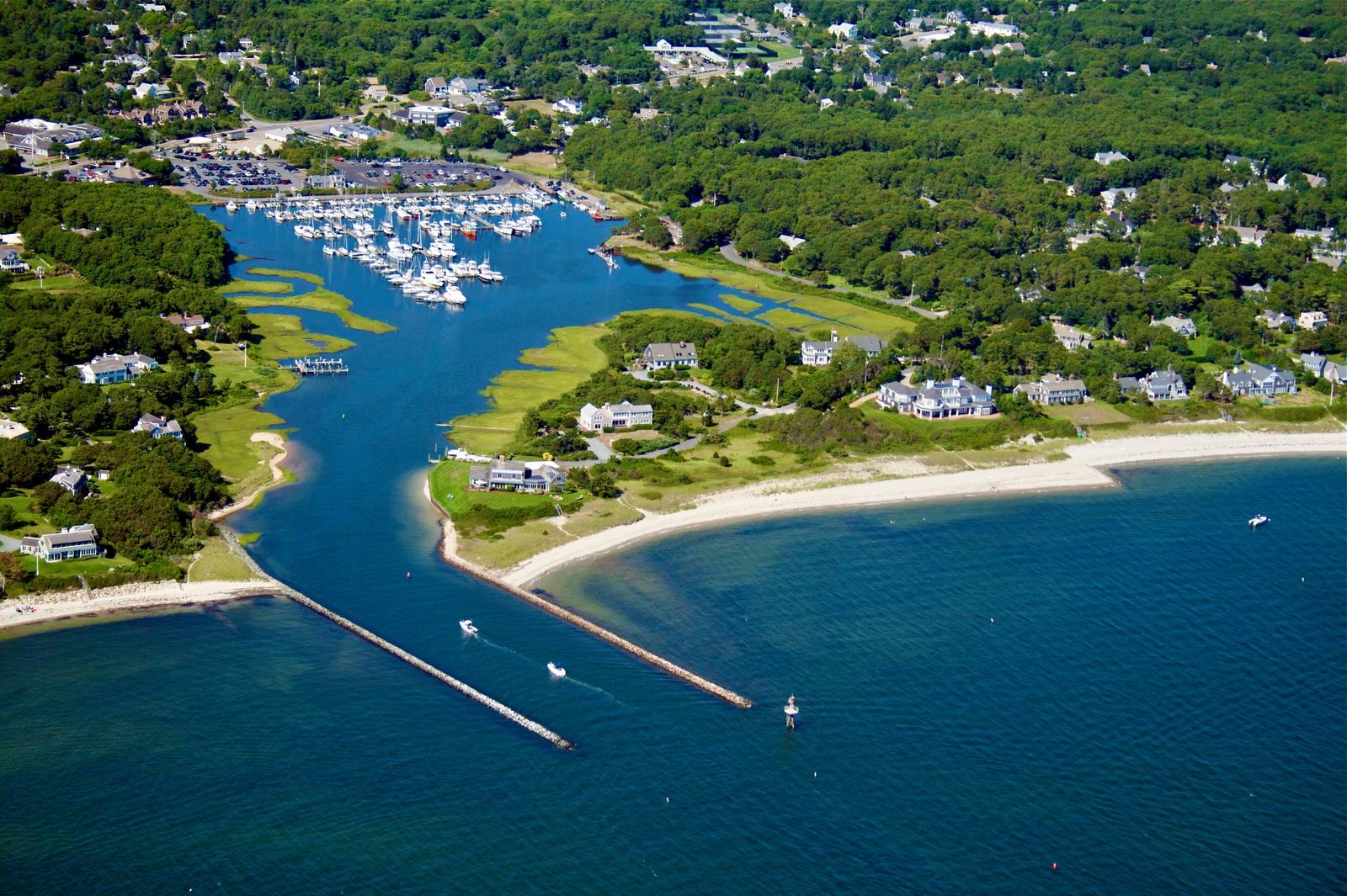 Aerial view of a Cape Cod harbour and the houses along its shore.
